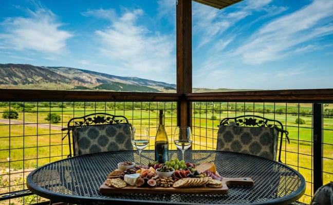 Rachael's Place deck with charcuterie and wine overlooking the Bighorn Mountains